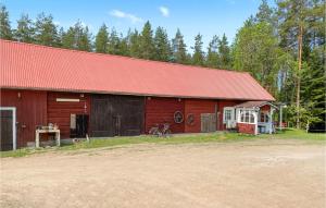 a red barn with a red roof at Amazing Apartment In Skrblacka With Kitchen in Skärblacka
