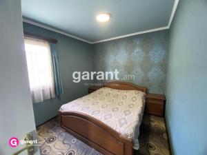 a bedroom with a bed and a window at Nirvana Resort in Sevan