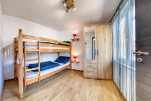 a bedroom with two bunk beds and a hallway at Holiday house "Laurus Garden" with private parking in Medulin