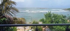 a view of the ocean from a balcony at Toddy by windy in Unawatuna