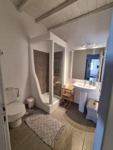 a bathroom with a toilet and a sink at Aviola Mykonos in Ftelia
