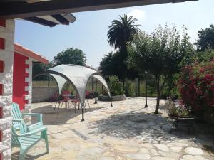 a patio with a gazebo and a table and chairs at Vibrant holiday home in Villanueva with terrace in Villanueva