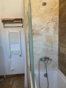 a bathroom with a shower and a bath tub at Super Center in Stara Zagora