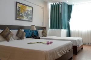 Voodi või voodid majutusasutuse Maison d'Hanoi Hotel toas