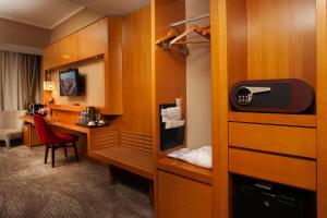 a room with a desk in a hotel room at Ramada Ulaanbaatar City Center in Ulaanbaatar