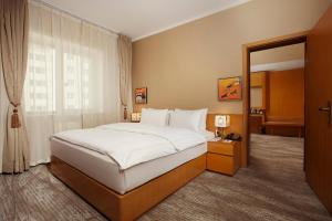 a hotel room with a large bed and a window at Ramada Ulaanbaatar City Center in Ulaanbaatar