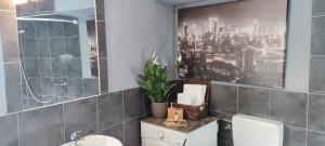 a bathroom with a toilet and a picture of a city at Art Gallery House in Crikvenica