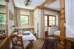 a bedroom with a bed and a table and chairs at Vronis Waldhaus ADULTS ONLY in Mayrhofen +60 photos