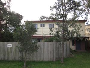 a fence in front of a house with a fence at Settlement Sands in Cowes +8 photos