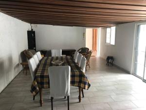 uma sala de jantar com mesa e cadeiras em Charmante villa située dans l’Est de l’île. em Sainte-Anne