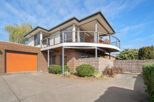 a large brick house with an orange garage at 3 at 35 Phillip Island Rd in San Remo
