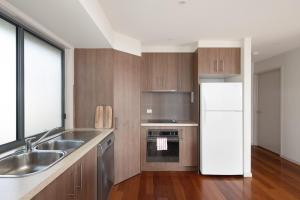 a kitchen with a sink and a refrigerator at 3 at 35 Phillip Island Rd in San Remo
