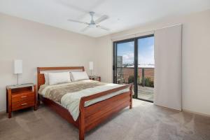 a bedroom with a bed and a large window at 3 at 35 Phillip Island Rd in San Remo