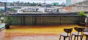 a view from the roof of a building with stools at Grandma House in Can Tho