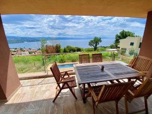 a table and chairs on a balcony with a view at Panorama Residence in Opatija