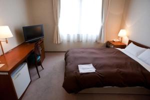 Postel nebo postele na pokoji v ubytování Utazu Grand Hotel