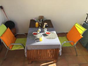 a table with two chairs and a table with food on it at Isla Canela Appartment in Isla Canela