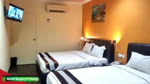 Voodi või voodid majutusasutuse Hotel Sunjoy9 Klang toas