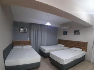 2 camas en una habitación de hotel con 2 camas en Villa Metaxa, en Paralia Katerinis