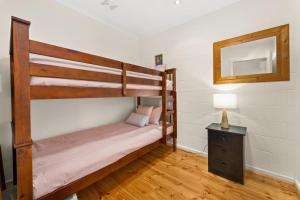 a bedroom with two bunk beds and a lamp at 4 of 5 Walpole Street in Cowes