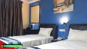 Voodi või voodid majutusasutuse Hotel Sunjoy9 Klang toas
