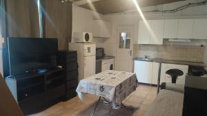 a kitchen with a table and a small kitchen with a table and a table at Studio charmant in Fontenay-sous-Bois