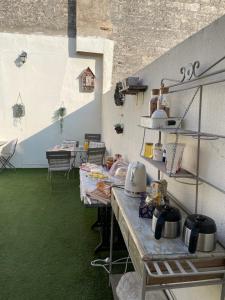 uma cozinha com uma mesa com panelas e frigideiras em Ô 36 Rempart Sud B&B em Aigues-Mortes