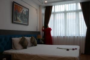 Voodi või voodid majutusasutuse Maison d'Hanoi Hotel toas