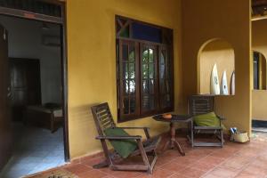 a room with two chairs and a table and a window at Mambo’s hotel Arugam Bay in Pottuvil +21 photos