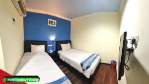 Voodi või voodid majutusasutuse Hotel Sunjoy9 Klang toas