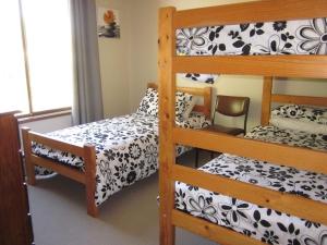a bedroom with two bunk beds and a bed at Beachcomber Bliss in Smiths Beach