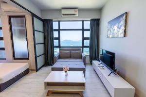 a living room with a couch and a tv at Margo Home - Jesselton Quay in Kota Kinabalu