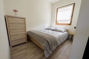 a small bedroom with a bed and a window at PRZYSTANEK G&S in Mikoszewo