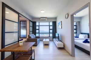 a hotel room with a bed and a living room at Margo Home - Jesselton Quay in Kota Kinabalu