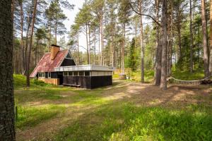 a cabin in the middle of a forest at Maro Guesthouse with Sauna in Vääna-Jõesuu