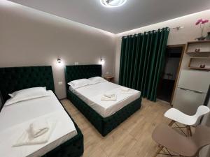 Postel nebo postele na pokoji v ubytování Guesthouse Dauti