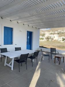 a large white table and chairs on a patio at Villa on the beach, Sarpakis Villa in Tzamaria