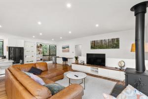 a living room with a couch and a fireplace at Otway Rest in Lorne