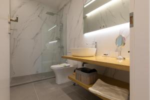 a bathroom with a sink and a toilet at Minimal apartment in Plaka in Athens