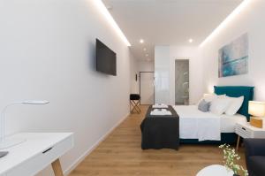 a bedroom with a bed with a table in it at Minimal apartment in Plaka in Athens