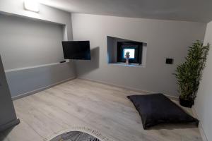 a living room with a flat screen tv on a wall at Assos Luxury Villas in Pefkochori