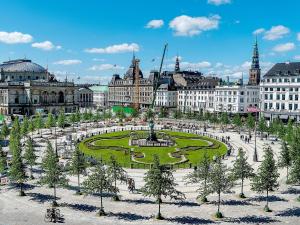 a city with a fountain in the middle of a park at Bright Apartment in the Old Town of Copenhagen in Copenhagen