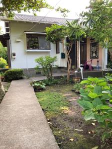 a house with a sidewalk in front of it at ＯＫＵＮＯ ＩＥ in Oshima