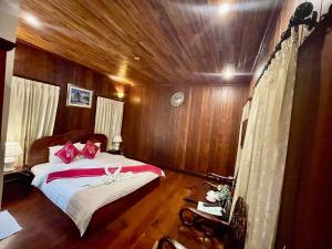 a bedroom with a bed on a boat at Villa Phathana Royal View Hotel in Luang Prabang