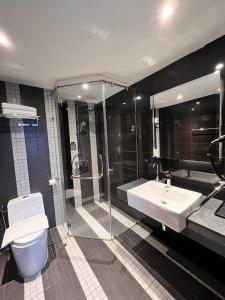 a bathroom with a shower and a toilet and a sink at Hotel Damai Kuala Lumpur in Kuala Lumpur +32 photos