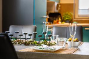 a table with wine glasses and a plate of food at Premiumferienhäuser Agena & Ankaa in Hasselfelde +24 photos