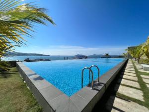 a swimming pool with a view of the water at Margo Home - Jesselton Quay in Kota Kinabalu