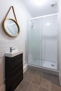 y baño con ducha, lavabo y espejo. en Trendy 2Bed flat Bethnal Green, en Londres
