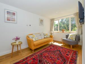 a living room with a couch and a chair at Bluebell Cottage in Tavistock