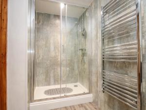 a shower with a glass door in a bathroom at RiversideThe West Dry in St Austell +28 photos
